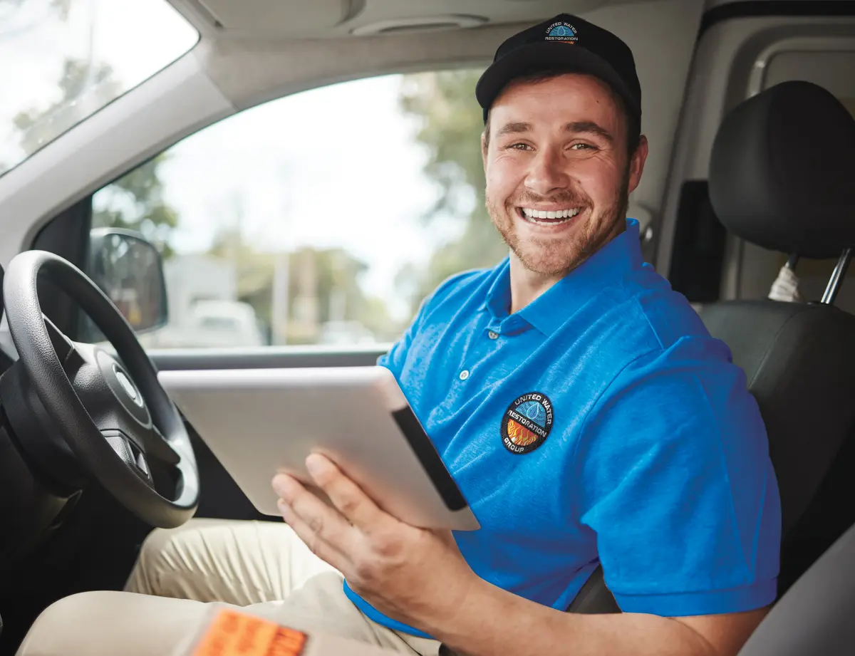 Technician documenting damage for an insurance claim